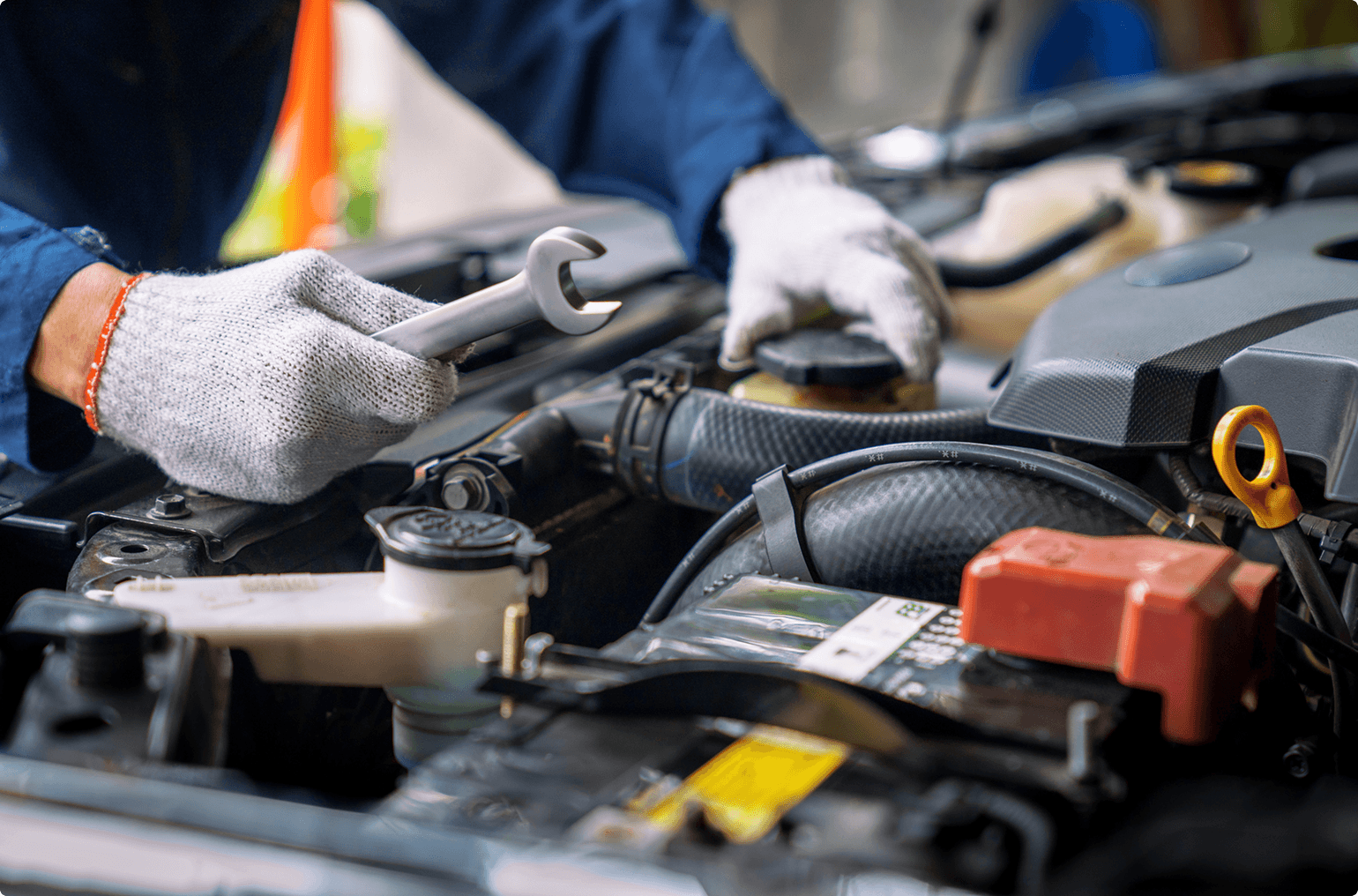 Hands repairing a car engine